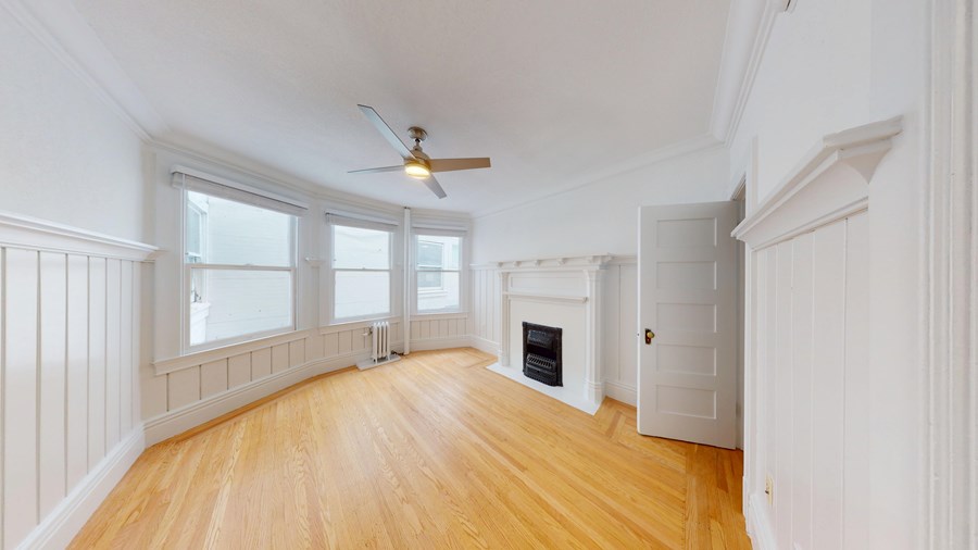A room with wooden floors and white walls.